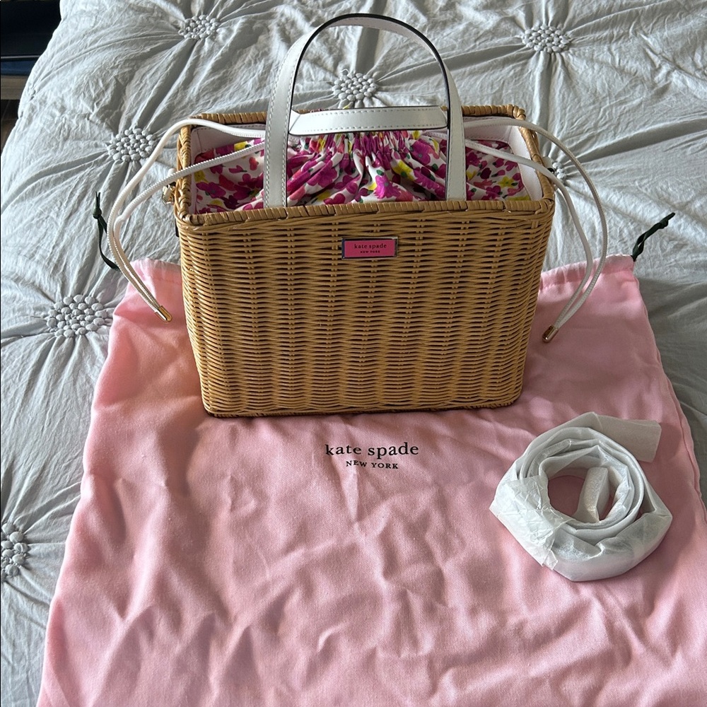 kate spade natural wicker tote with white handles and pink floral liner